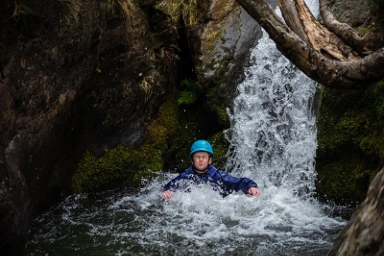 Boy in waterfall